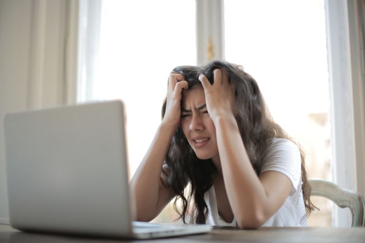 A young woman distressed while translating documents